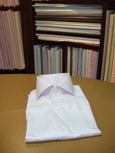 Shelves of shirting cloth and a finished shirt