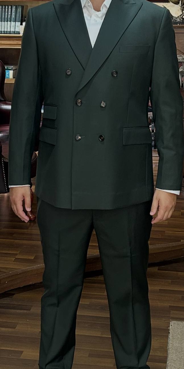 A dark green double-breasted suit with a white shirt